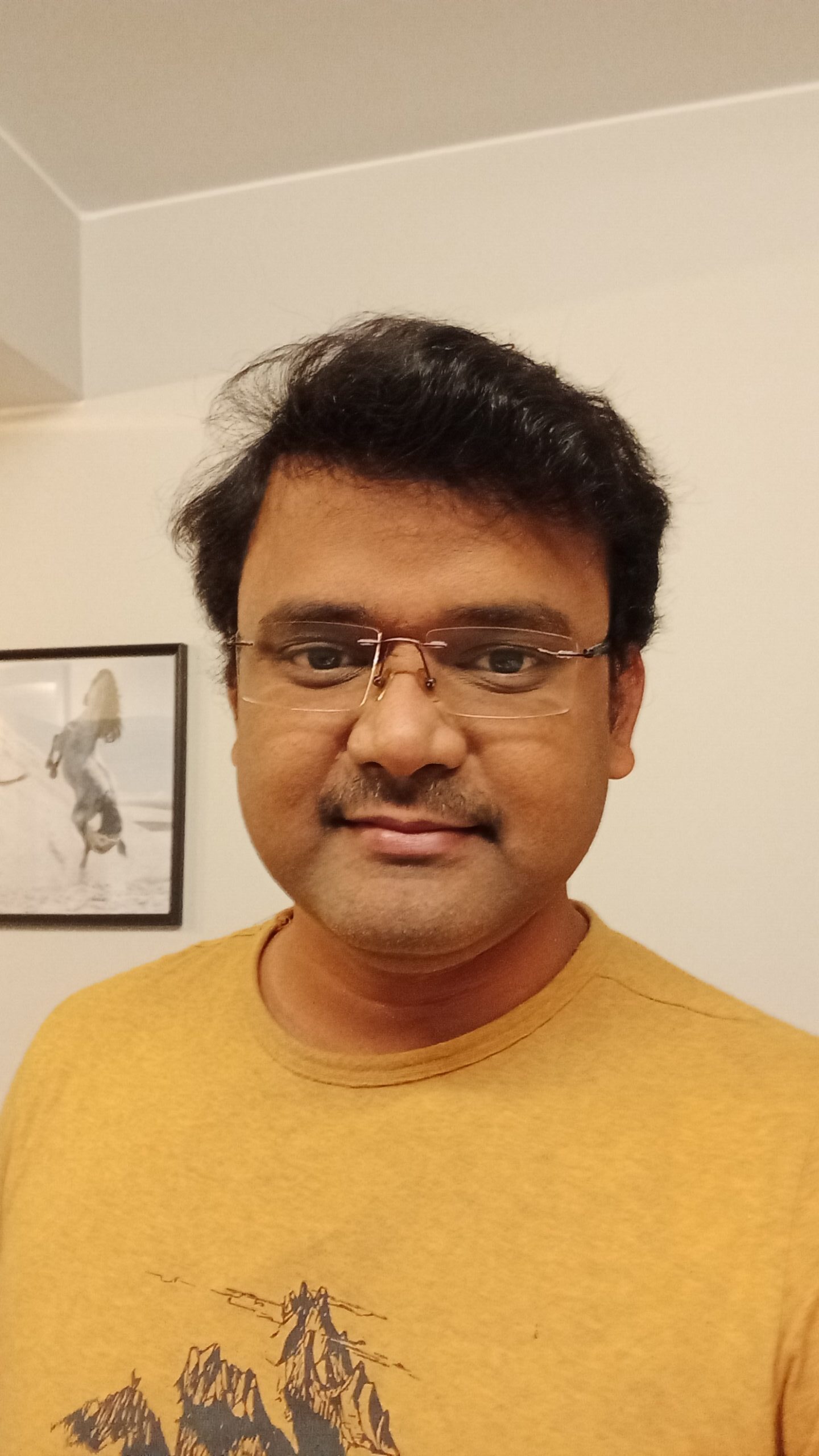 a-person-wearing-glasses-and-a-yellow-shirt-descr A person wearing glasses and a yellow shirt Description automatically generated
